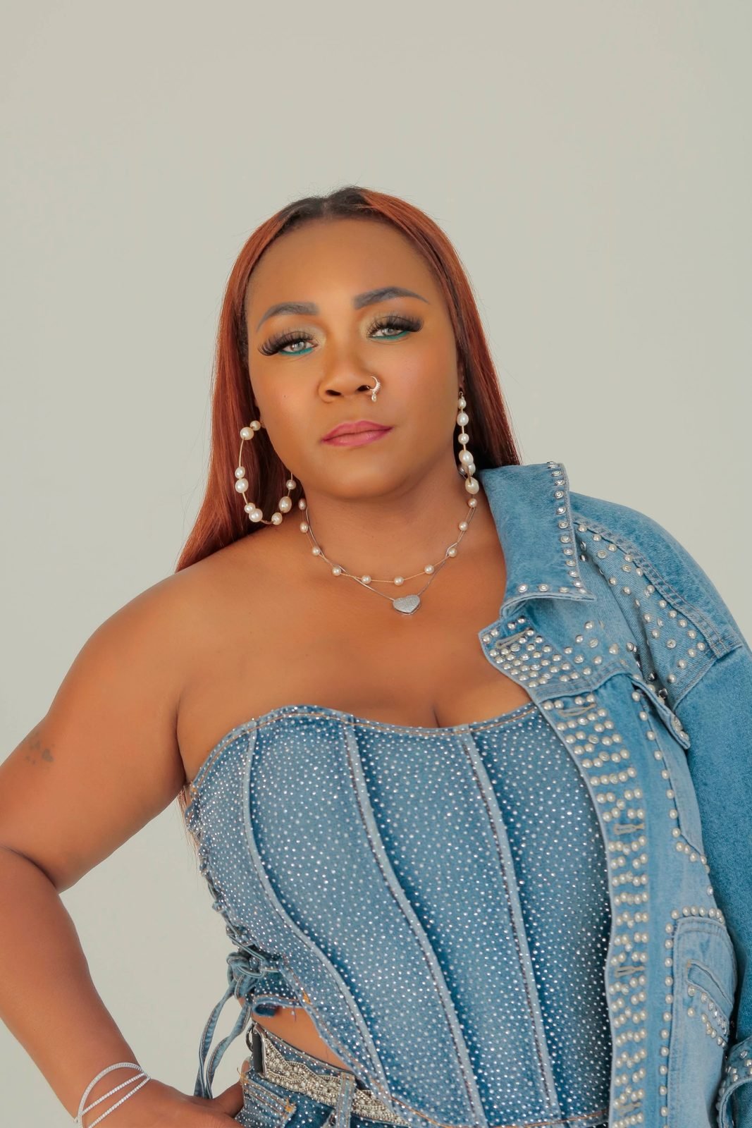 Jay Plush in a rhinestone denim corset and studded jacket